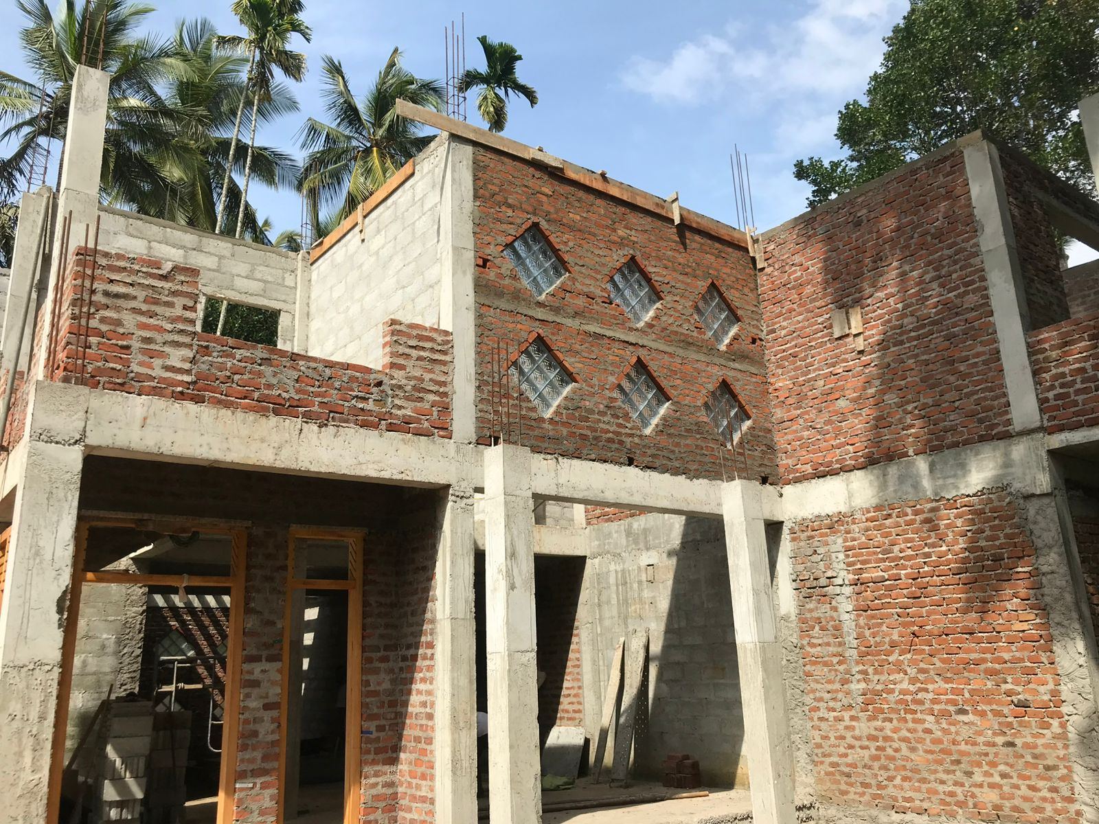 Two-storey brick walls of a house in mid-construction
